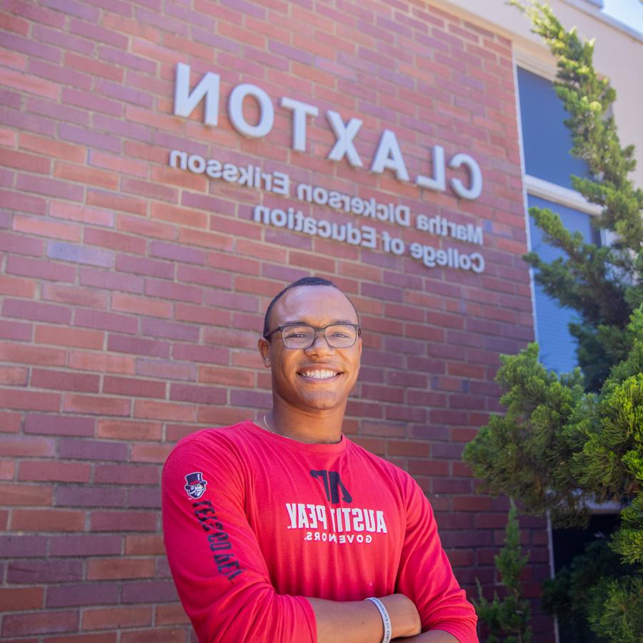 Student standing outside infront of the Claxton building